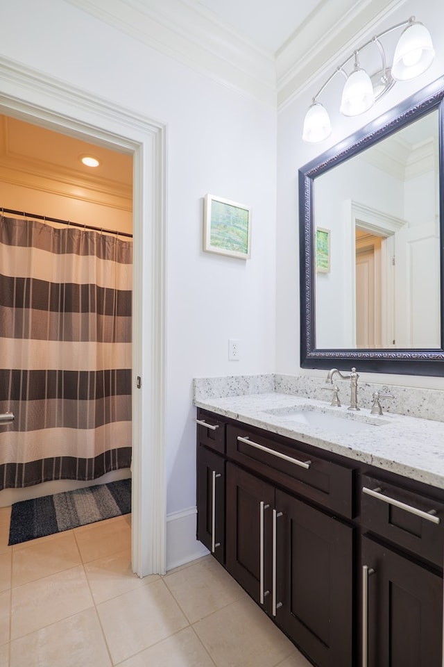 bathroom with crown molding, tile patterned floors, and vanity