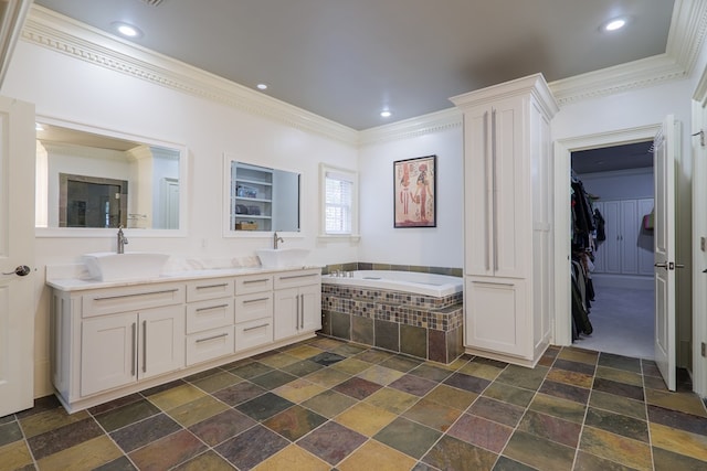 bathroom featuring crown molding, vanity, and a relaxing tiled tub