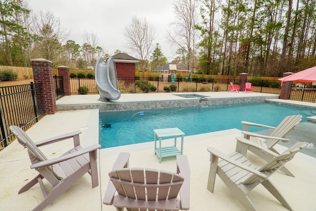 view of swimming pool featuring a water slide and a patio area