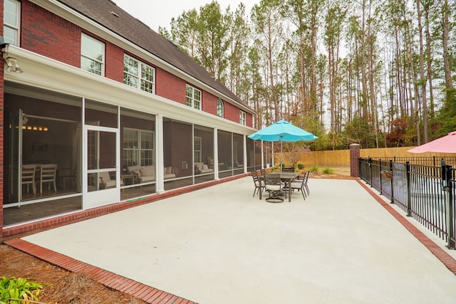 view of patio with a sunroom