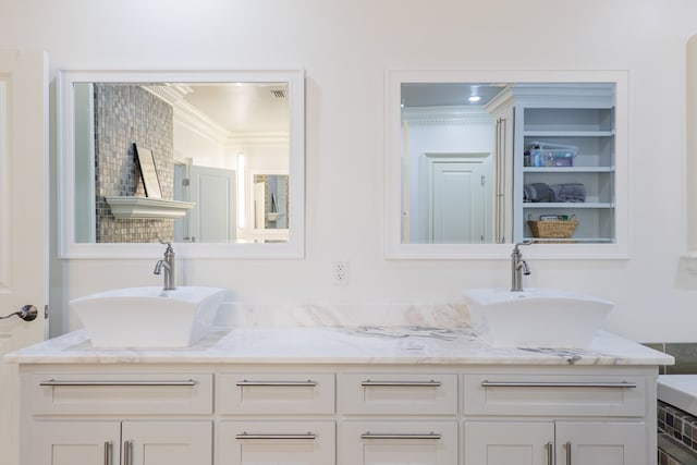 bathroom featuring crown molding and vanity