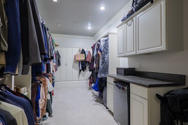 spacious closet featuring light colored carpet