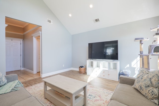 living area featuring visible vents, baseboards, and wood finished floors