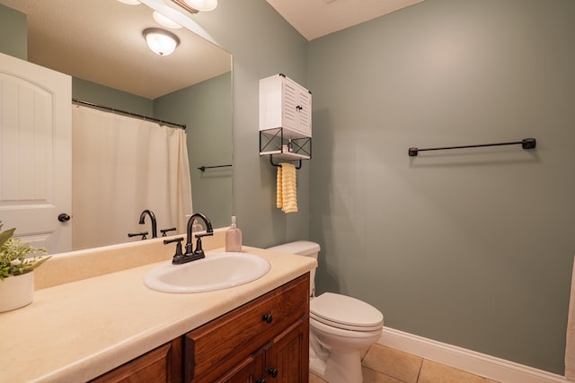 bathroom featuring tile patterned flooring, toilet, vanity, and baseboards