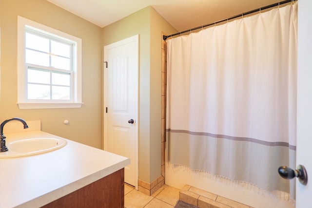 full bathroom with tile patterned floors and vanity