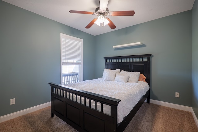 carpeted bedroom featuring baseboards and a ceiling fan