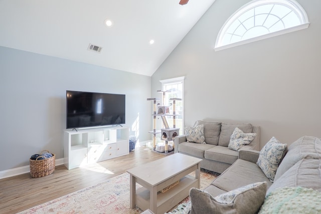 living room with visible vents, baseboards, recessed lighting, wood finished floors, and high vaulted ceiling