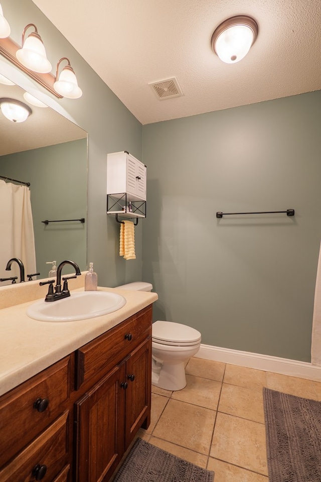 full bathroom with visible vents, baseboards, toilet, tile patterned floors, and vanity