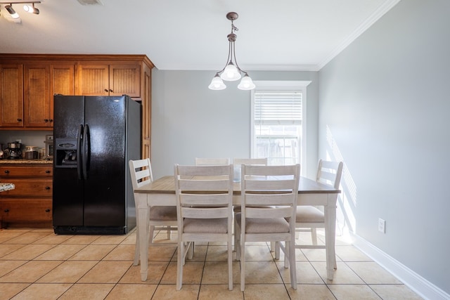 dining room featuring light tile patterned flooring, visible vents, crown molding, and baseboards