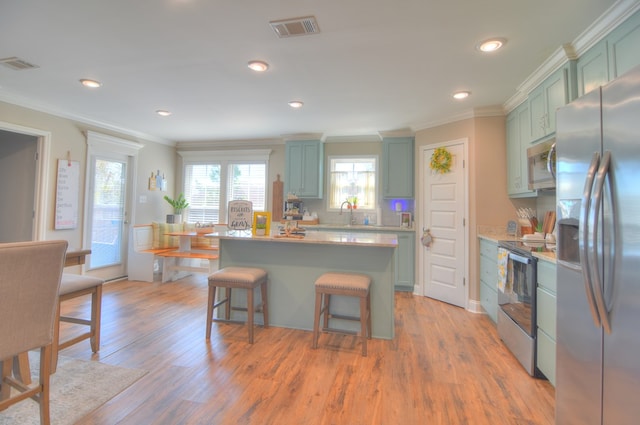 kitchen with light countertops, visible vents, appliances with stainless steel finishes, and green cabinetry