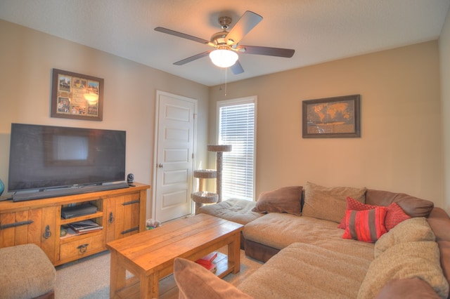 living area with a ceiling fan and light carpet