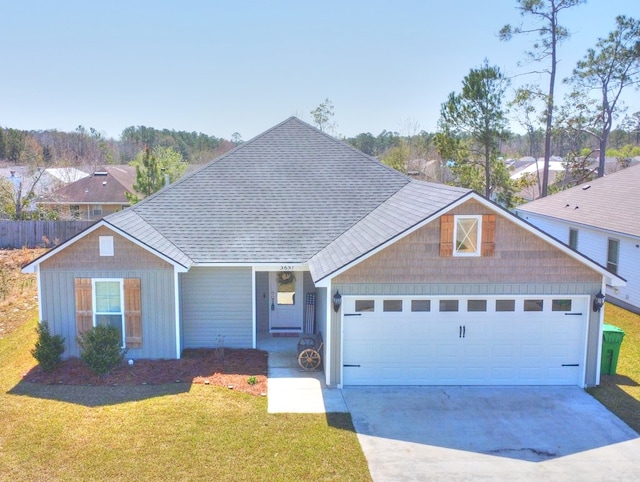 ranch-style house with driveway, an attached garage, a front lawn, and roof with shingles