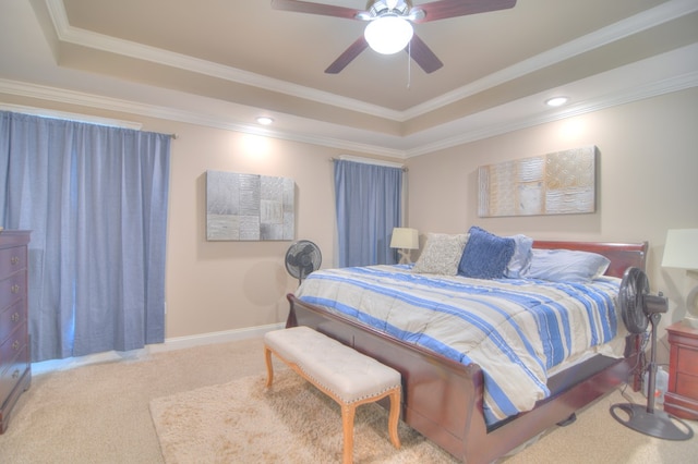 bedroom with crown molding, baseboards, carpet, and a tray ceiling