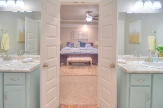 ensuite bathroom featuring connected bathroom, vanity, a ceiling fan, and ornamental molding