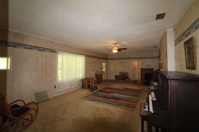 carpeted living room featuring a textured ceiling and ceiling fan