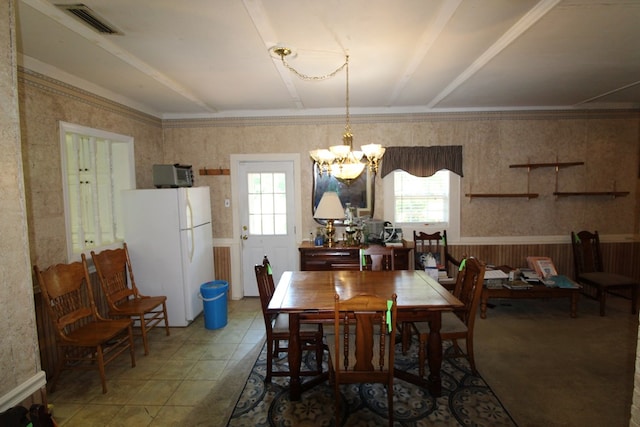 dining area with an inviting chandelier