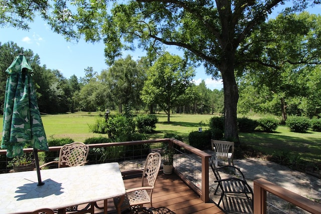 wooden terrace with a yard