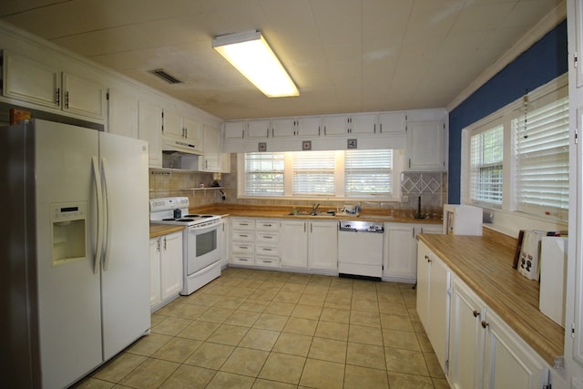 kitchen with white cabinets, white appliances, a healthy amount of sunlight, and sink