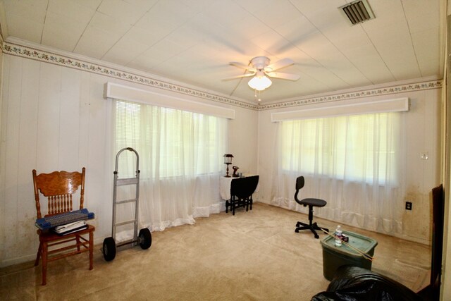 interior space with ceiling fan and light carpet