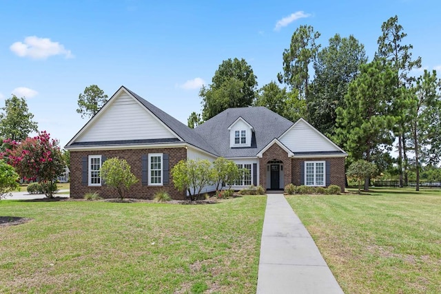 traditional home featuring a front yard and brick siding