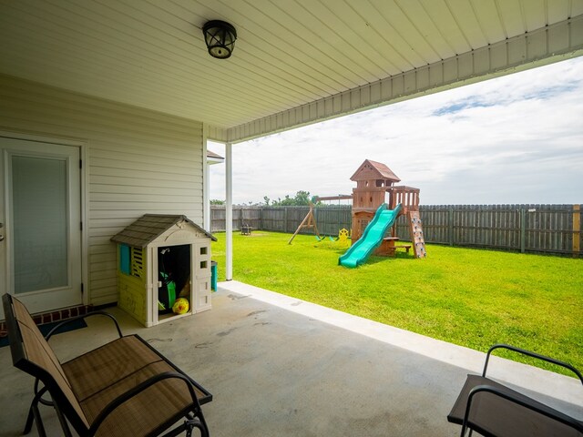 3956 Crusader Ct, Valdosta, GA 31605 - fenced backyard featuring a playground, a patio, and a storage shed