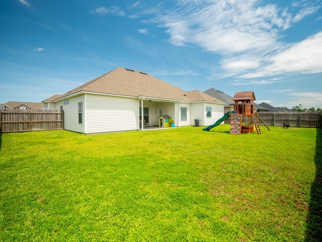 3956 Crusader Ct, Valdosta, GA 31605 - rear view of house with a playground and a fenced backyard