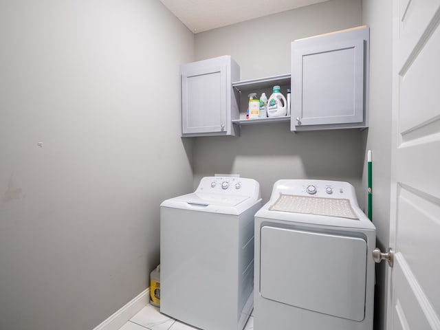 3956 Crusader Ct, Valdosta, GA 31605 - washroom with cabinet space, washing machine and clothes dryer, and light tile patterned flooring