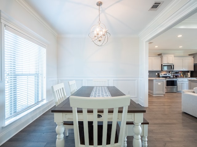 3956 Crusader Ct, Valdosta, GA 31605 - dining space with a chandelier, crown molding, a wainscoted wall, a decorative wall, and wood finished floors