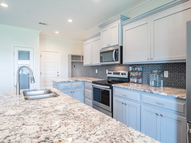 3956 Crusader Ct, Valdosta, GA 31605 - kitchen featuring appliances with stainless steel finishes, ornamental molding, backsplash, recessed lighting, and light stone countertops