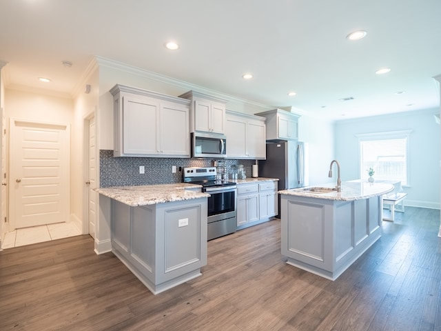 3956 Crusader Ct, Valdosta, GA 31605 - kitchen featuring stainless steel appliances, ornamental molding, tasteful backsplash, wood finished floors, and recessed lighting