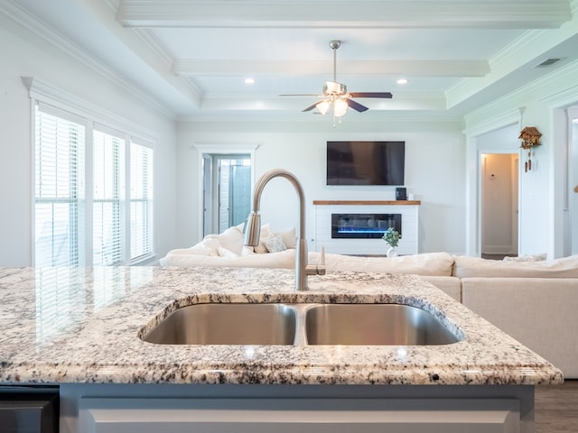 3956 Crusader Ct, Valdosta, GA 31605 - kitchen featuring open floor plan, light stone counters, beamed ceiling, ceiling fan, and wood finished floors