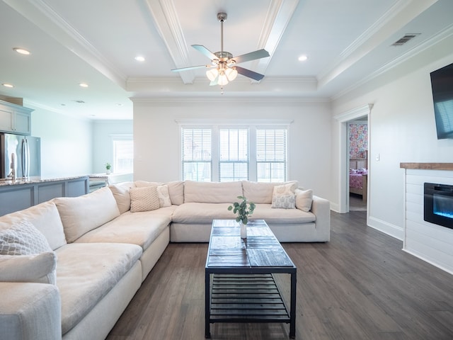 3956 Crusader Ct, Valdosta, GA 31605 - living room featuring a ceiling fan, dark wood finished floors, a glass covered fireplace, crown molding, and recessed lighting