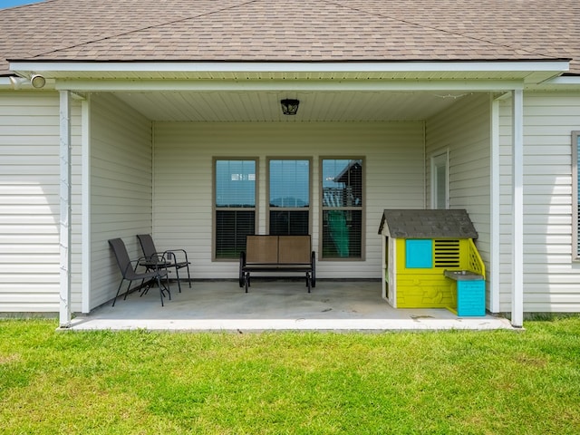 3956 Crusader Ct, Valdosta, GA 31605 - back of property with a patio, a lawn, and roof with shingles