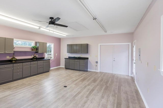 561 Sevilla Spring Cir, Lake Park, GA 31636 - unfurnished living room with attic access, a ceiling fan, light wood finished floors, baseboards, and cooling unit