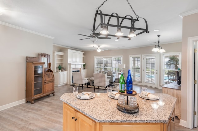 561 Sevilla Spring Cir, Lake Park, GA 31636 - kitchen with ceiling fan, light brown cabinets, crown molding, light wood-type flooring, and baseboards