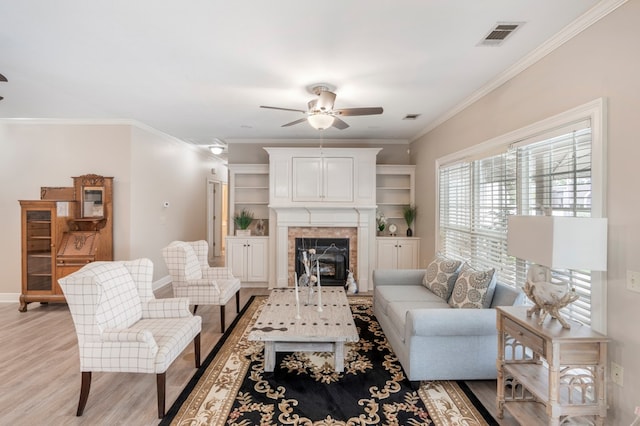 561 Sevilla Spring Cir, Lake Park, GA 31636 - living area featuring ceiling fan, light wood-style floors, ornamental molding, baseboards, and a fireplace