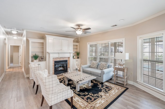 561 Sevilla Spring Cir, Lake Park, GA 31636 - living room with ceiling fan, baseboards, light wood-type flooring, ornamental molding, and a tiled fireplace