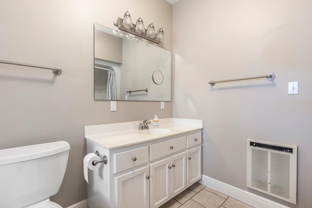 561 Sevilla Spring Cir, Lake Park, GA 31636 - bathroom with heating unit, vanity, toilet, baseboards, and tile patterned floors