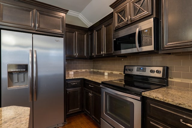 kitchen with light stone counters, tasteful backsplash, and stainless steel appliances