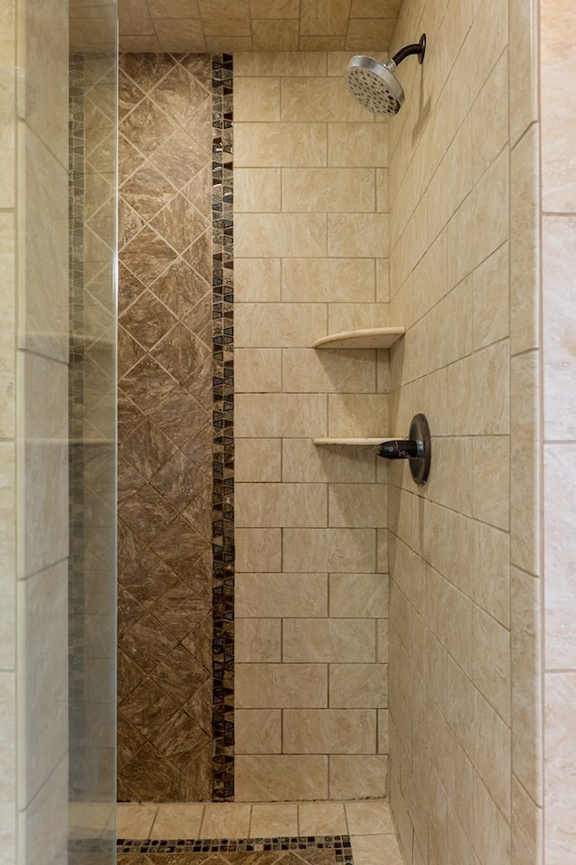 bathroom with a tile shower