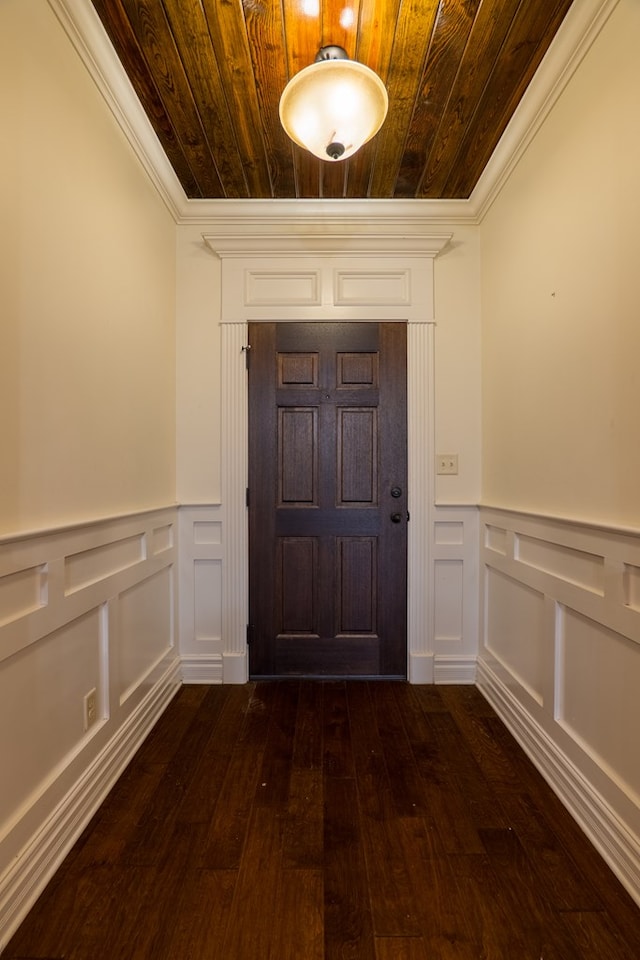 entryway featuring ornamental molding, dark hardwood / wood-style floors, and wood ceiling