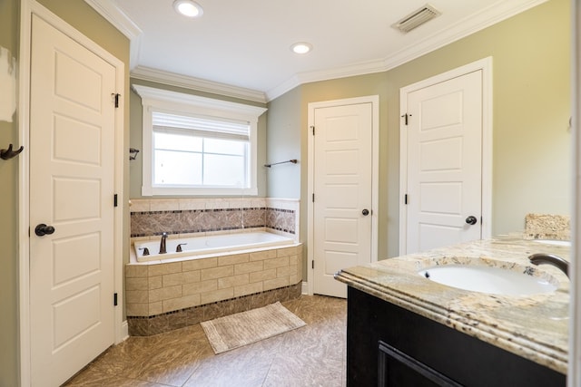 bathroom with crown molding, tiled bath, and vanity