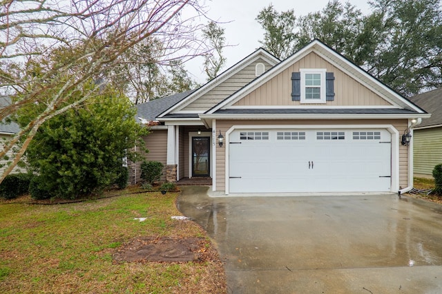 craftsman-style home featuring a garage and a front yard