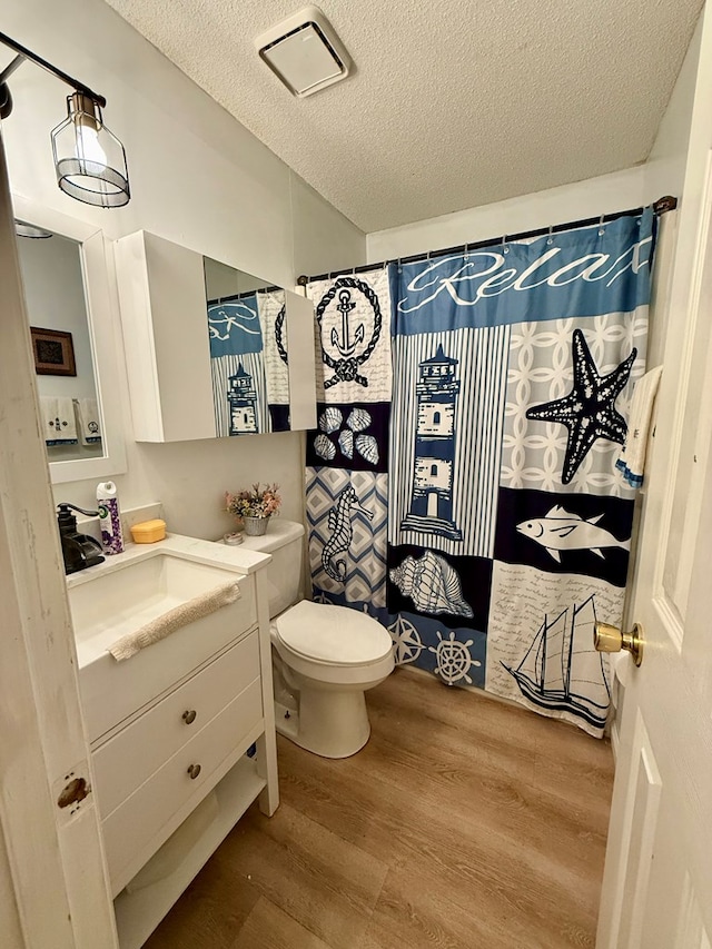 325 Jennifer Cir, Valdosta, GA 31605 - bathroom with vanity, wood finished floors, a textured ceiling, and a shower with curtain
