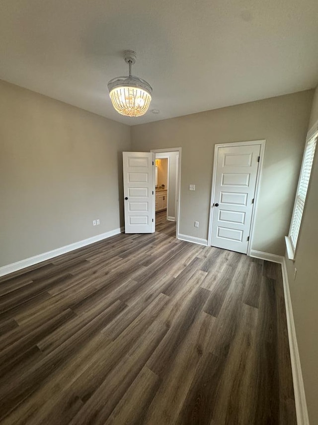 unfurnished bedroom with dark hardwood / wood-style flooring