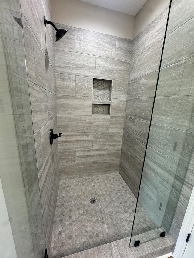 bathroom with a tile shower