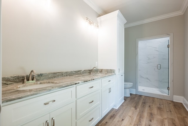 bathroom featuring an enclosed shower, vanity, crown molding, hardwood / wood-style floors, and toilet