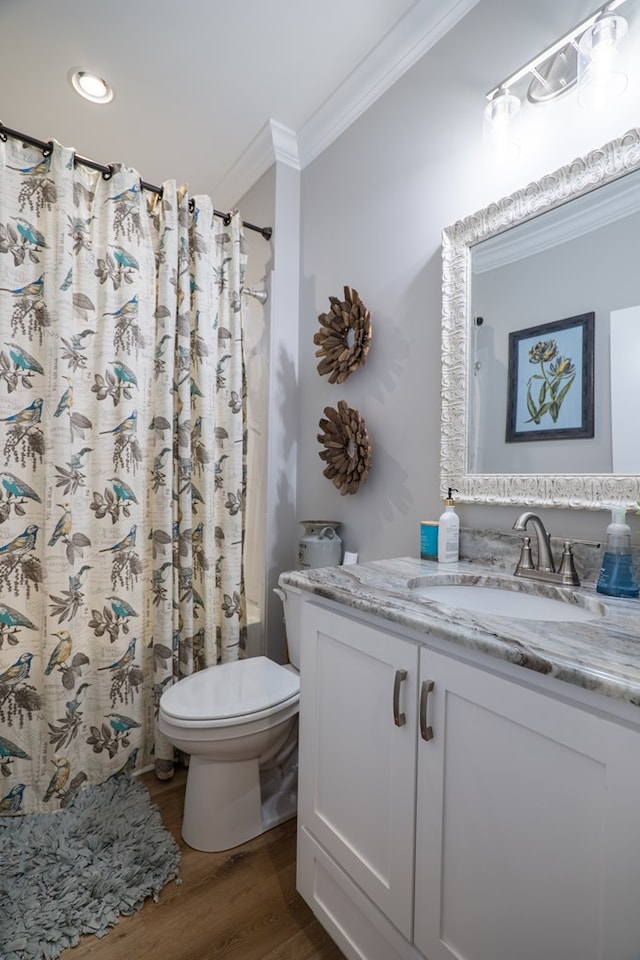 full bathroom with shower / bath combo, ornamental molding, vanity, hardwood / wood-style floors, and toilet