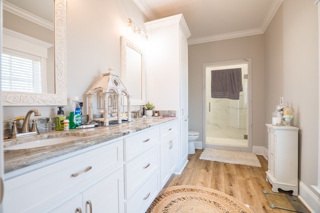 bathroom featuring crown molding, hardwood / wood-style floors, an enclosed shower, toilet, and vanity