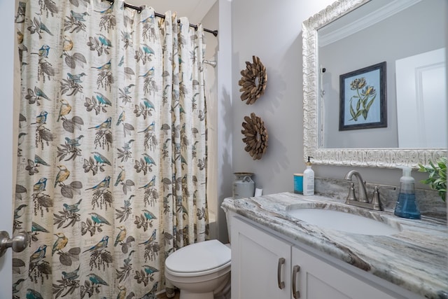 bathroom featuring a shower with shower curtain, vanity, toilet, and crown molding